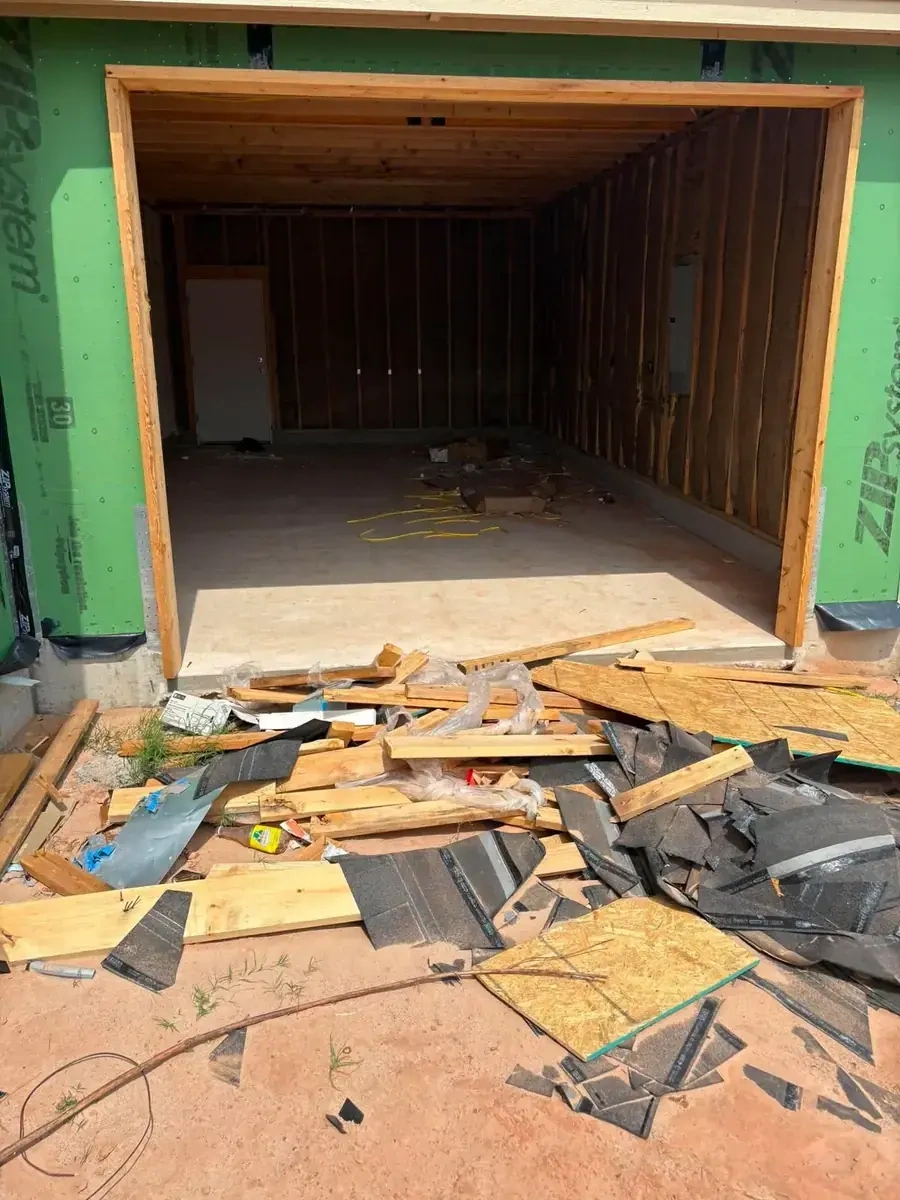 Construction site debris and roofing materials before removal